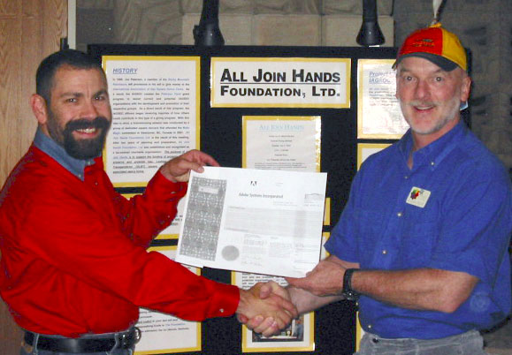 Andy Shore presents a stock donation to All Join Hands Foundation